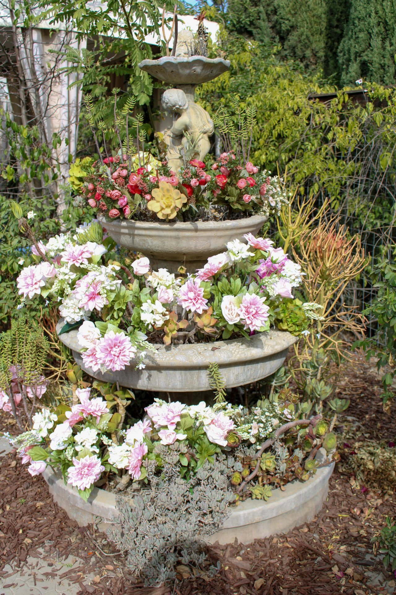 Tiered stone fountain with flowers